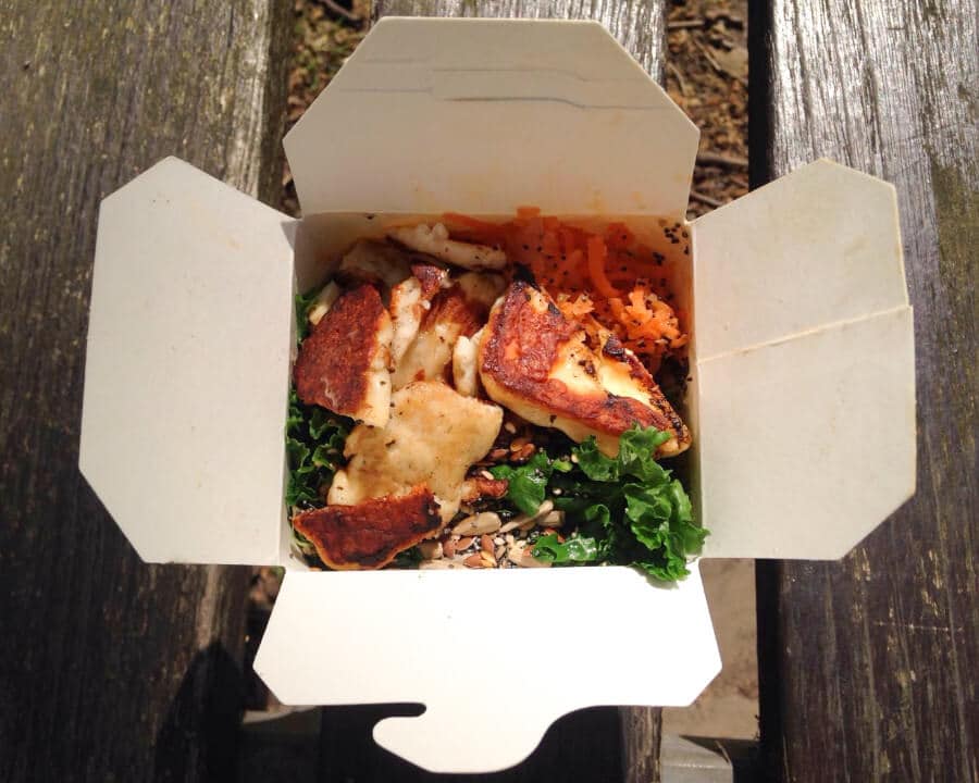 Takeaway carton filled with salad and halloumi.