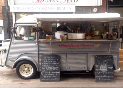 Citroën van, open at the side, with two people serving food.