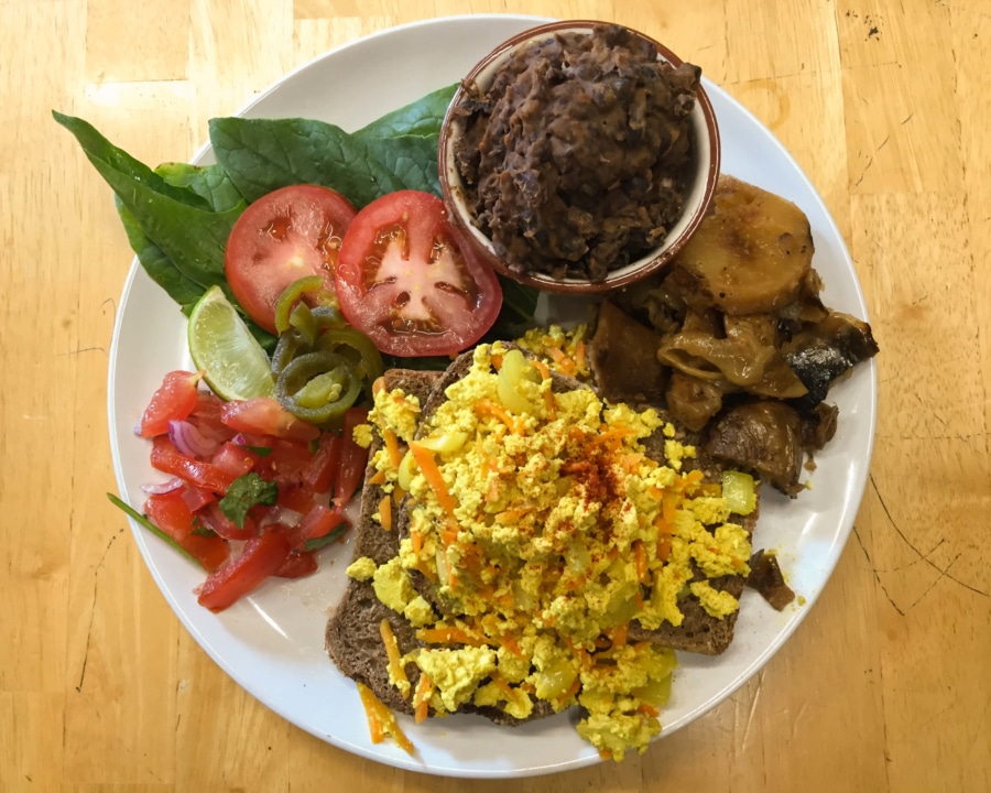 Tofu scramble on bread with potatoes, refried beans and salad.