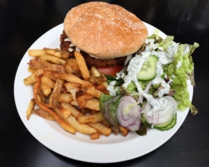 Burger with chips and salad.