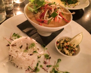 Thai green curry with rice and condiments.
