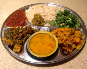 Two curries with rice, salad and dhal.