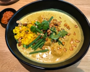 Sweet potato and green bean curry with rice and chili sauce.