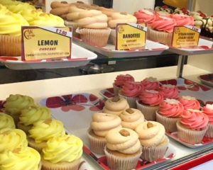 Rows of cupcakes on baking trays.