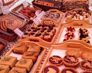 Rows of cakes, tarts and cupcakes.