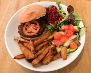 Burger with chips and salad.