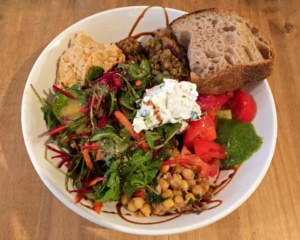 Mixed salad with hummus and bread.