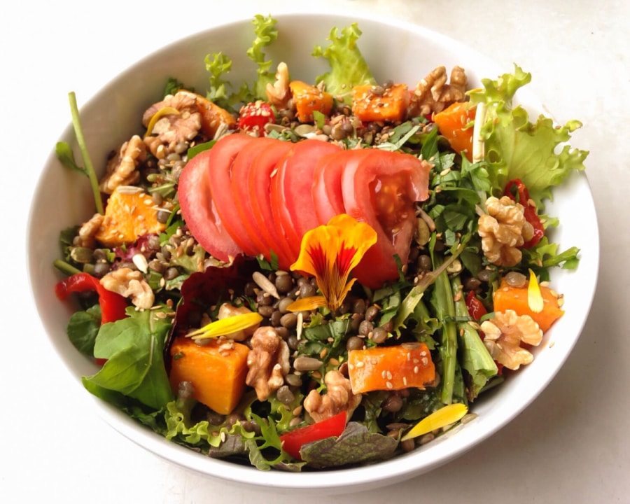 Butternut squash and walnut salad with tomato.
