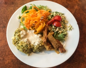 Broad bean patties with garam flour chips and greens.