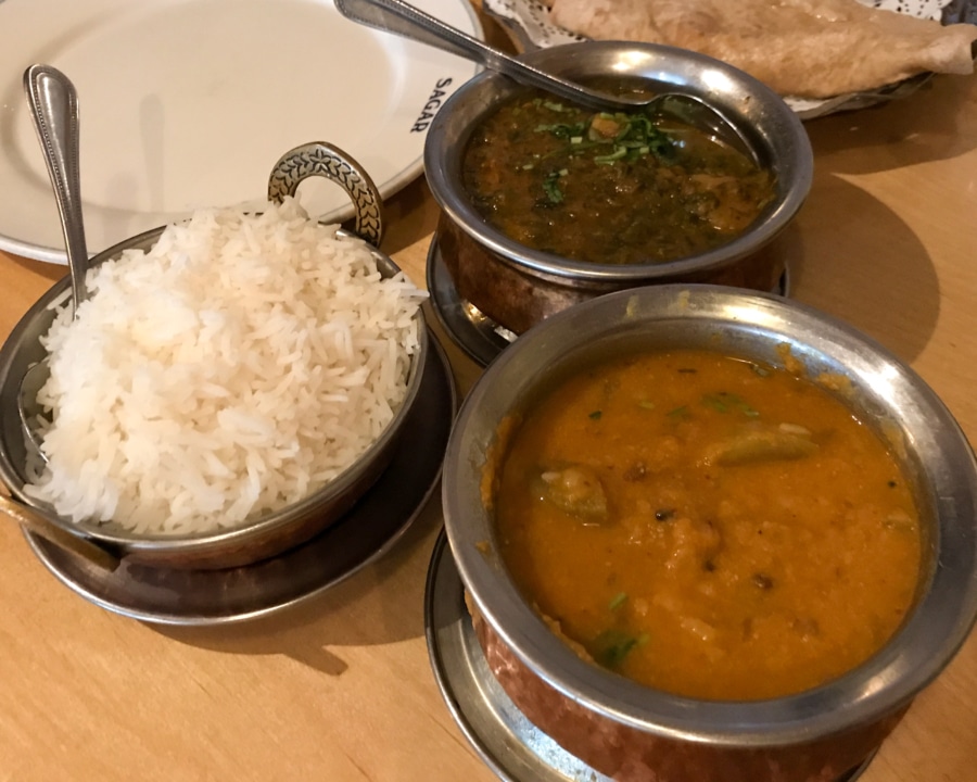 Assorted dishes of curries and rice.